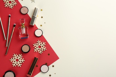 Flat lay composition with decorative cosmetic products on color background, space for text. Winter care