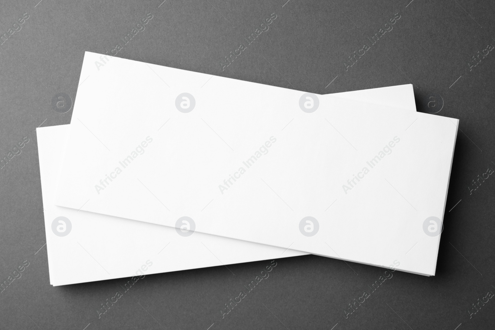 Photo of Blank business cards on dark grey background, top view. Mock up for design