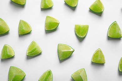 Composition with fresh ripe limes on white background, top view