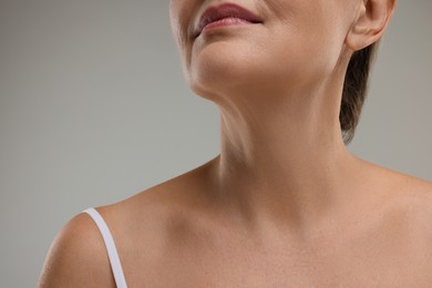 Photo of Mature woman with healthy skin on grey background, closeup