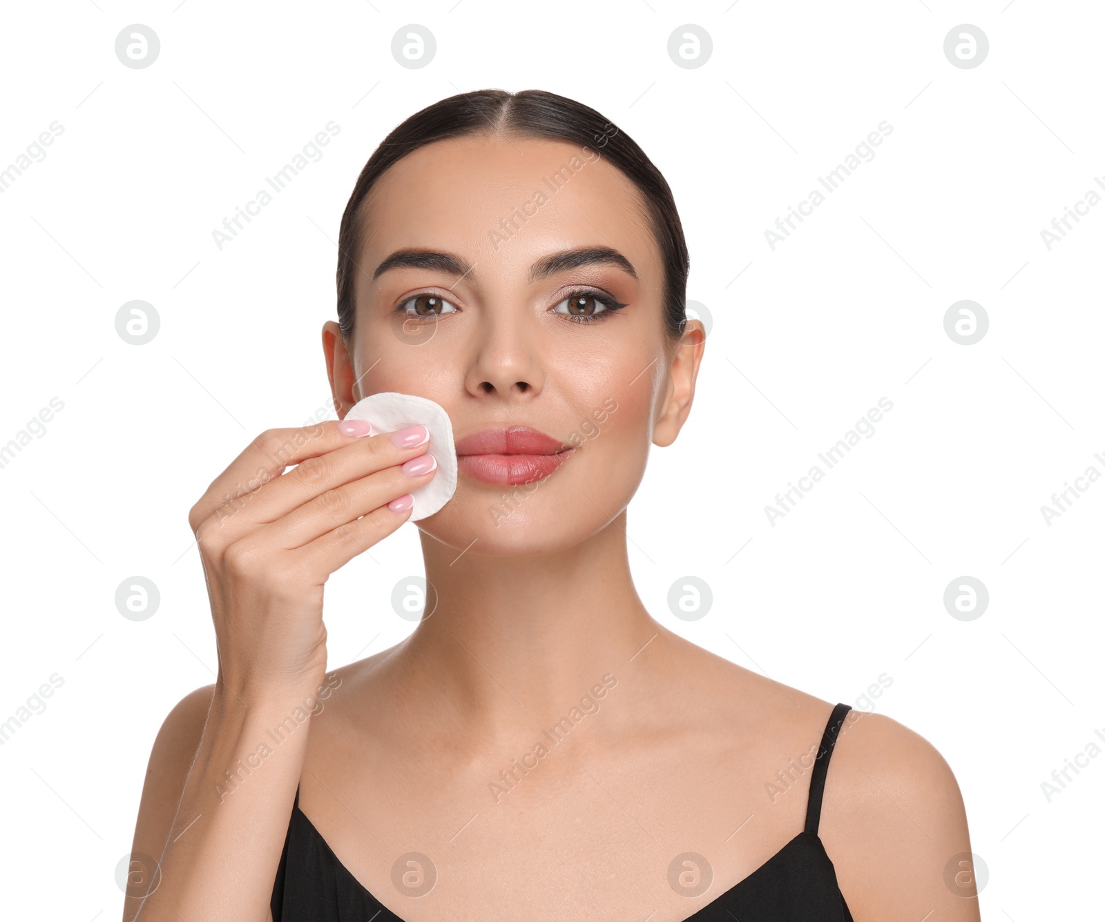 Photo of Beautiful woman removing makeup with cotton pad on white background