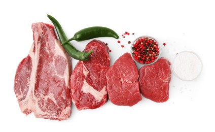 Photo of Cut fresh beef meat with spices on white background, top view
