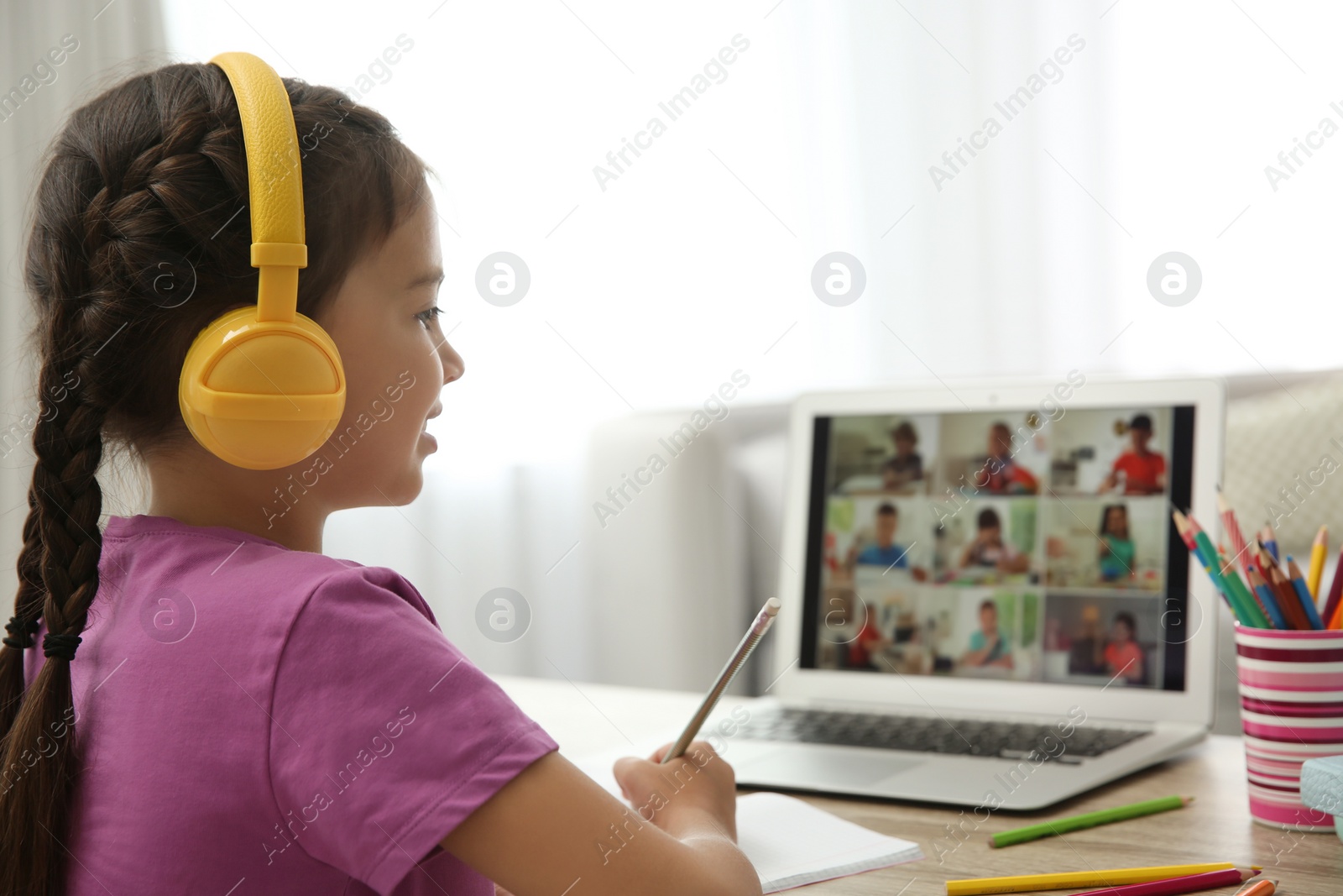 Photo of Distance learning during quarantine and lockdown due to Covid-19 pandemic. Girl having online school lesson with class indoors