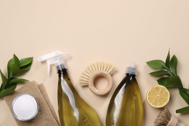 Photo of Flat lay composition with different cleaning supplies on beige background. Space for text