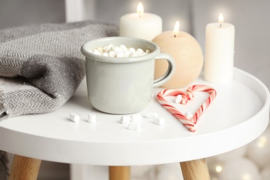 Composition with cup of hot winter drink on table. Cozy season