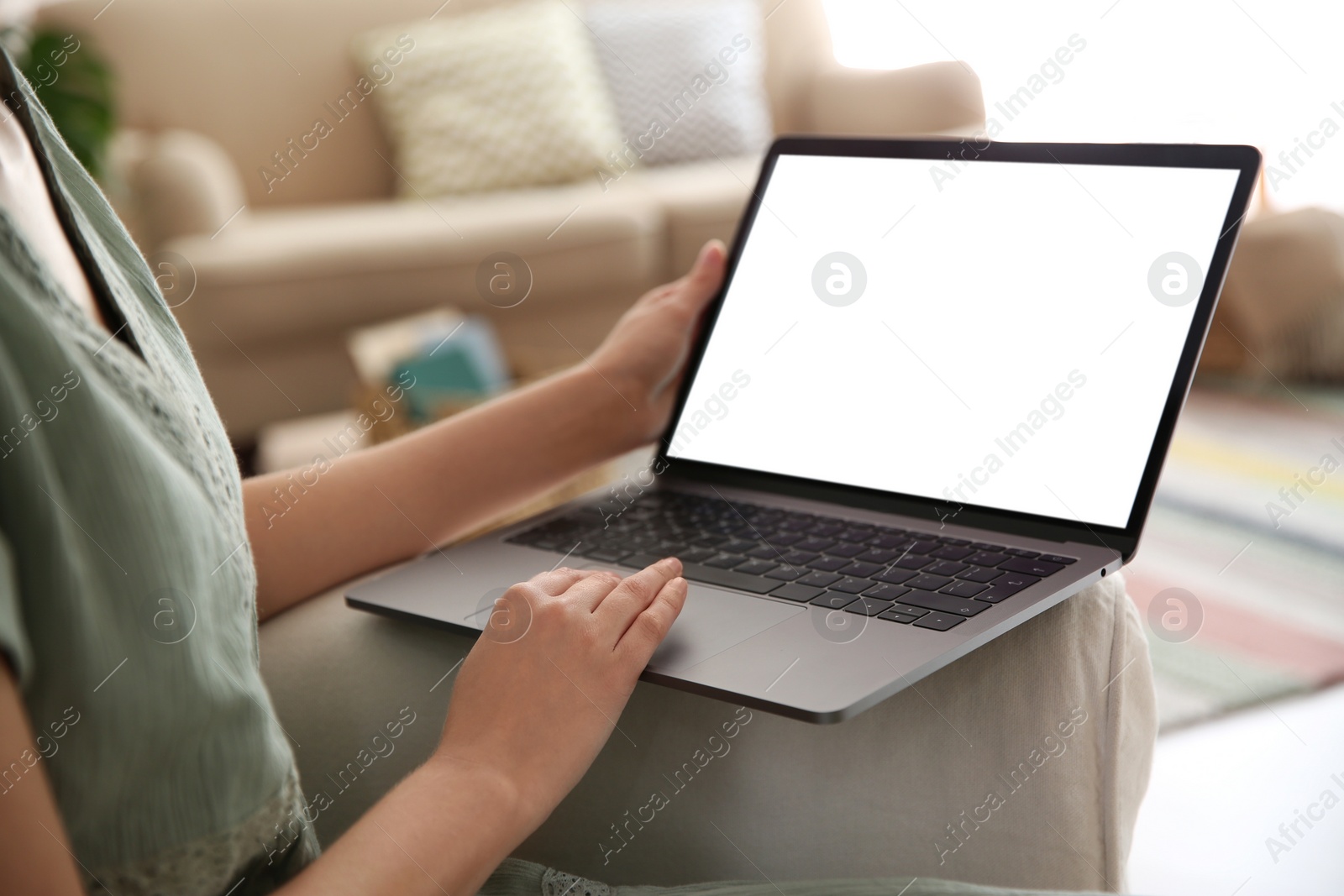 Photo of Woman using laptop at home, closeup. Space for design