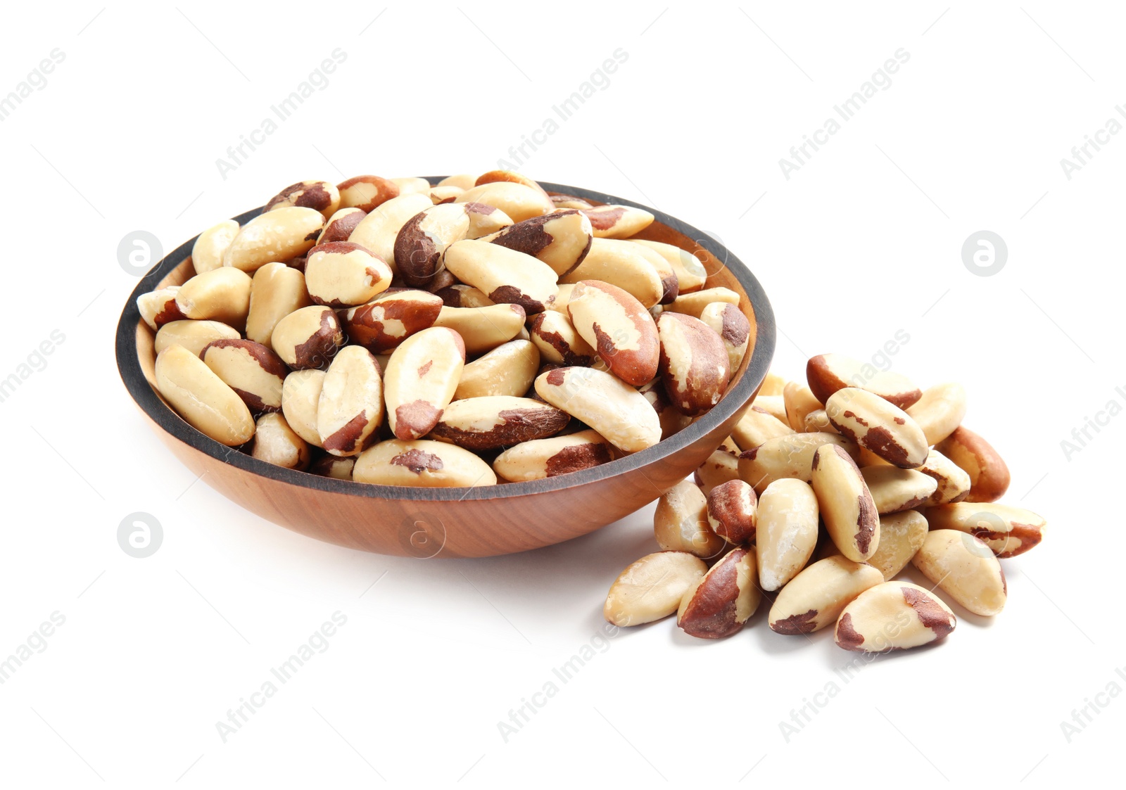 Photo of Wooden bowl with Brazil nuts on white background