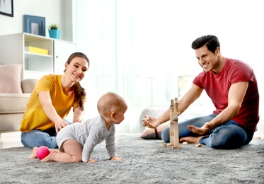 Photo of Adorable little baby crawling near parents at home