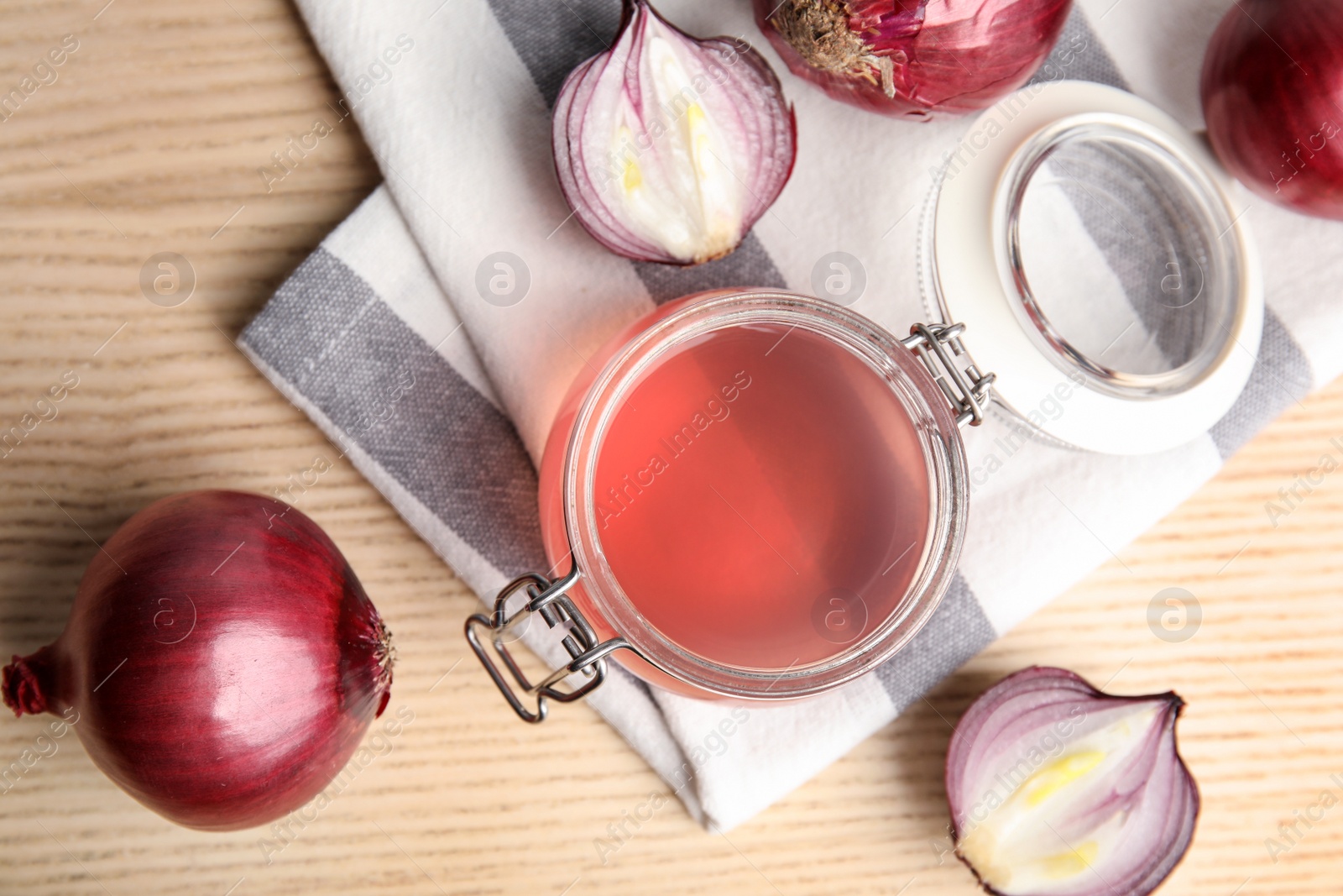 Photo of Flat lay composition with onion syrup in jar and ingredient on table