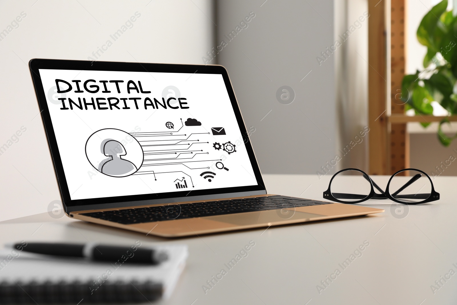 Image of Laptop with text Digital Inheritance and scheme with many different icons on screen. Workplace with device on table