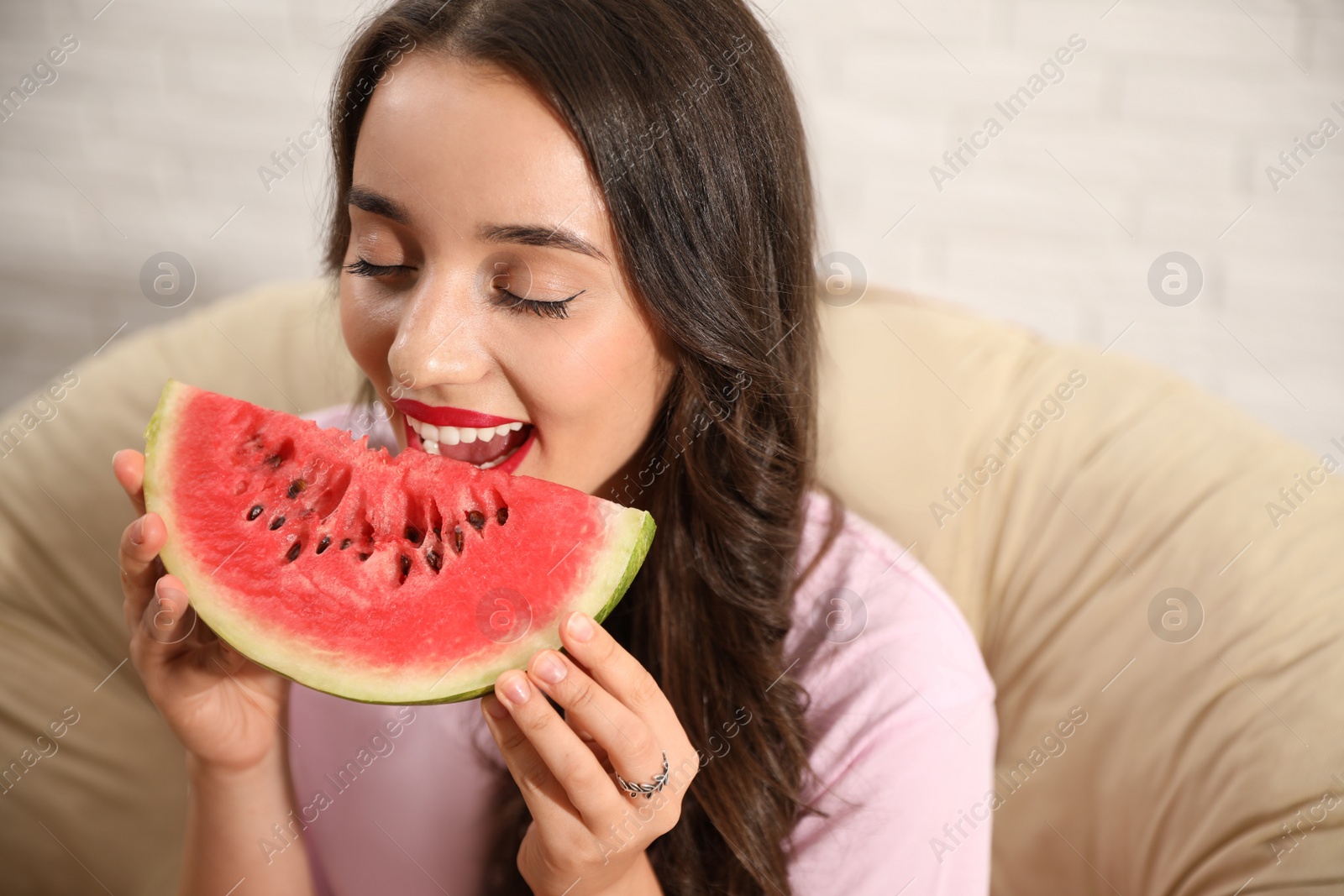 Photo of Beautiful young woman with watermelon on chair