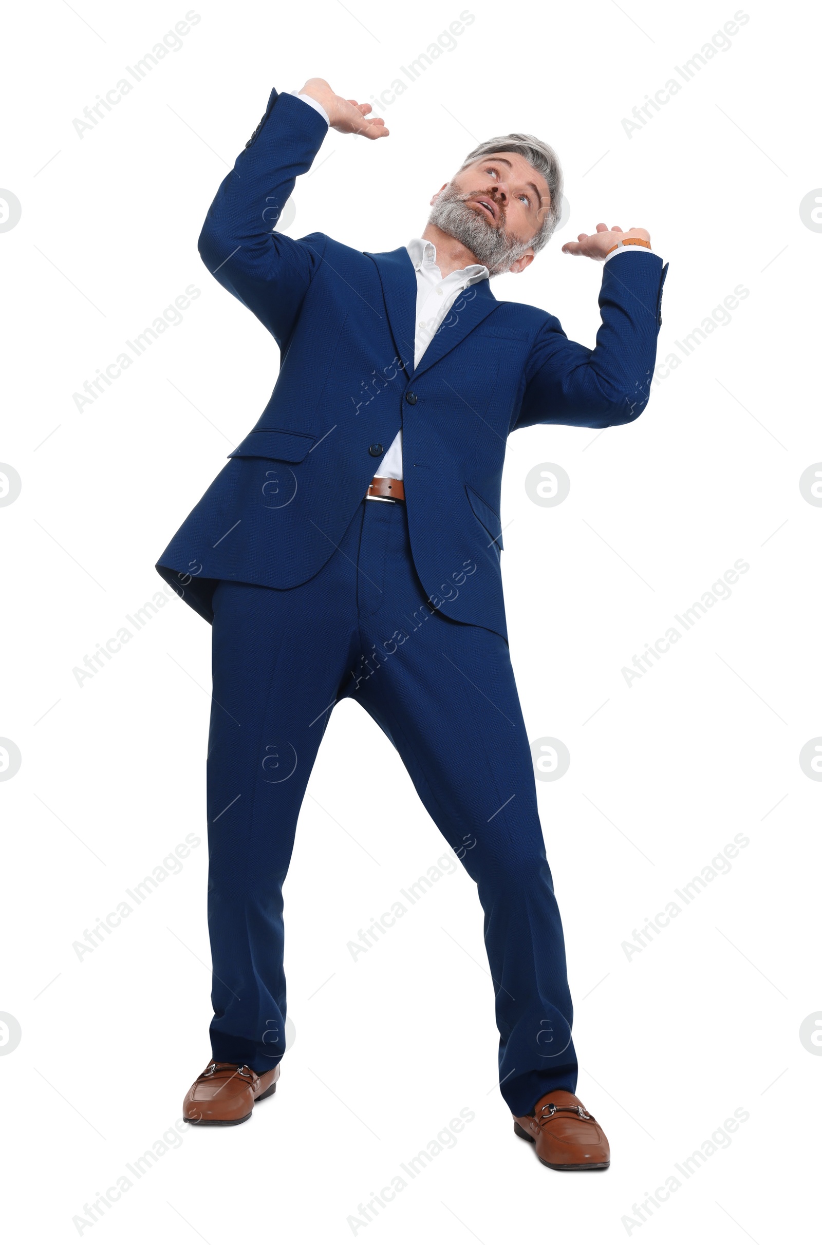 Photo of Mature businessman in stylish clothes avoiding something on white background