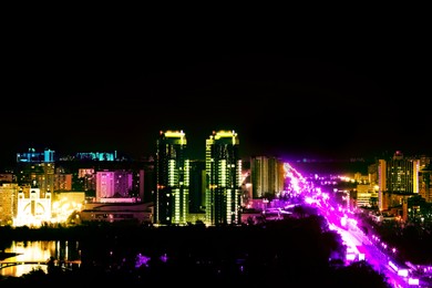 Image of Dark cityscape with beautiful neon lights. Modern metropolis