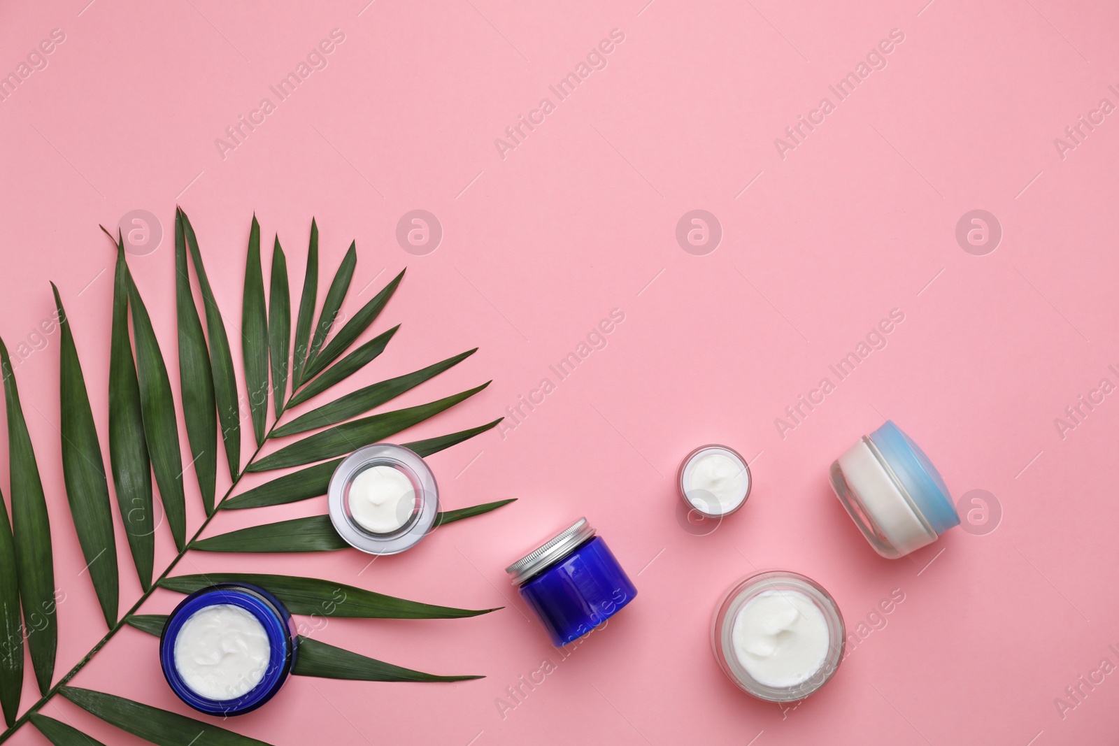 Photo of Flat lay composition with cosmetic products on color background