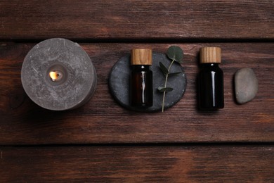 Flat lay composition with spa products and eucalyptus branch on wooden table