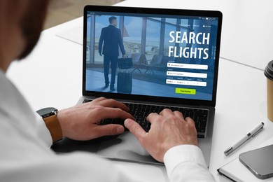 Image of Man using laptop to book flight at white table, closeup