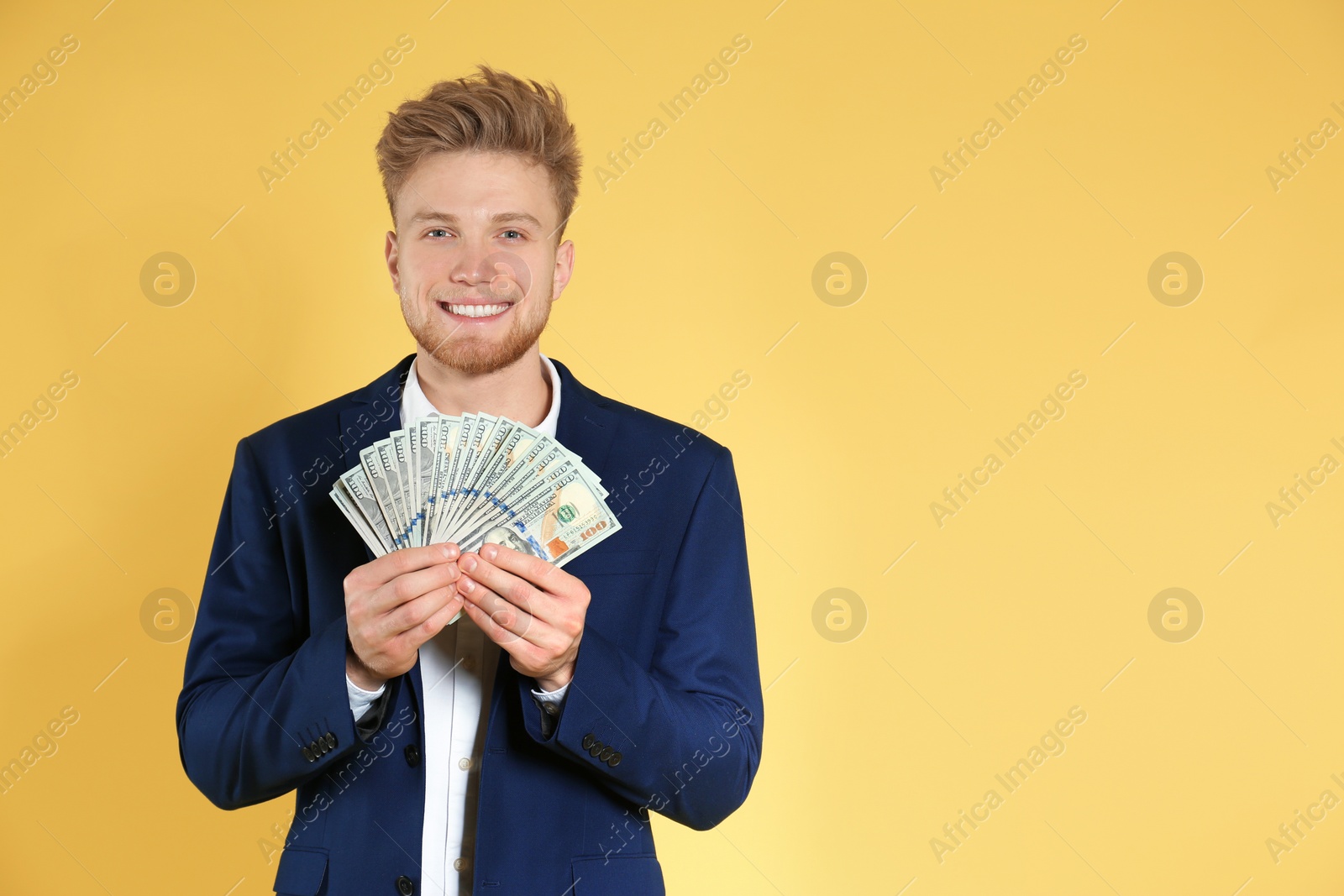 Photo of Businessman with money on color background. Space for text