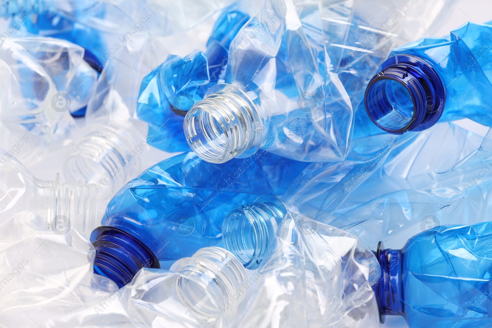 Photo of Crumpled disposable plastic bottles as background, closeup