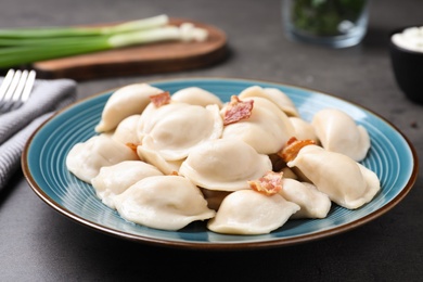 Photo of Plate of tasty cooked dumplings on table