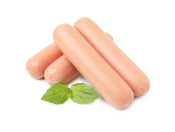 Delicious boiled sausages and basil on white background