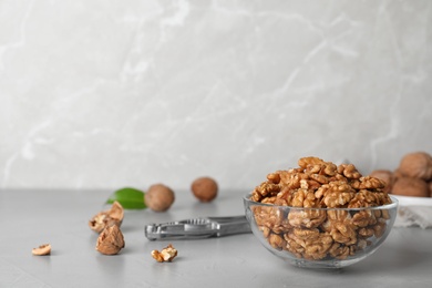 Photo of Composition with walnuts in bowl on table. Space for text