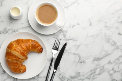 Photo of Delicious fresh croissant served with coffee on light marble table, flat lay. Space for text