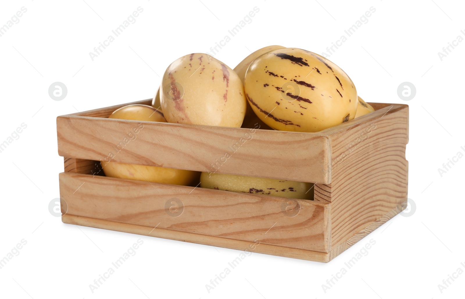 Photo of Fresh ripe pepino melons in wooden crate on white background