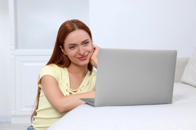 Photo of Woman having video chat via laptop at home