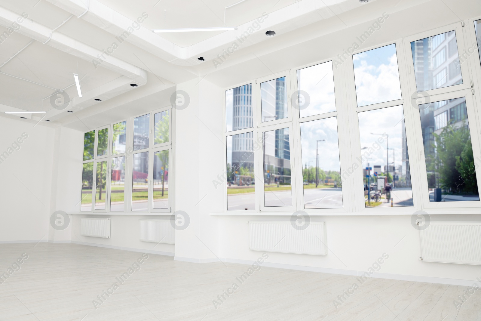 Photo of Modern office room with white walls and windows. Interior design