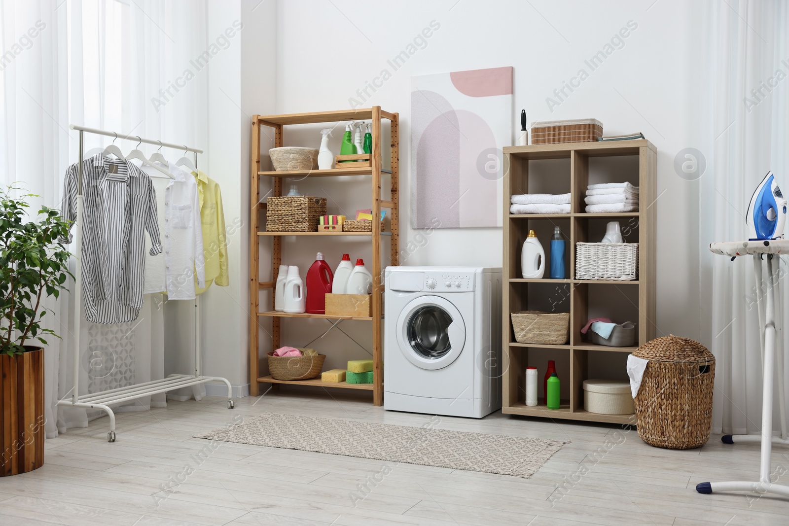 Photo of Laundry room interior with washing machine and furniture