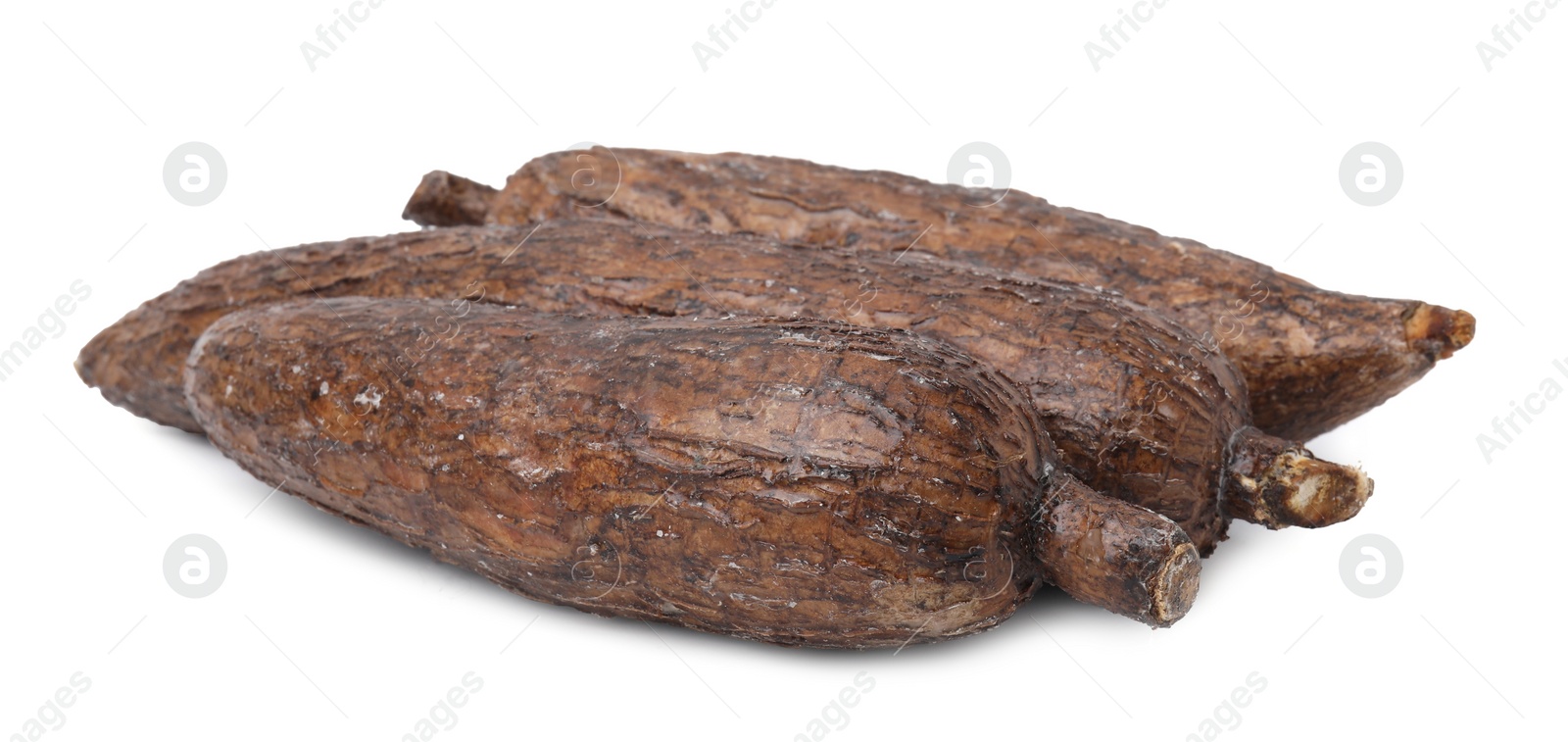 Photo of Three whole ripe cassava roots isolated on white