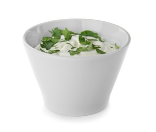 Photo of Bowl with sour cream and herbs on white background