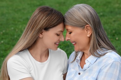 Photo of Happy mature mother and her daughter outdoors