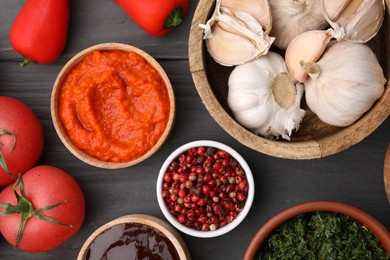 Photo of Different fresh marinades in bowls and ingredients on grey wooden table, flat lay