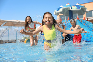 Photo of Happy family having fun at water park. Summer vacation