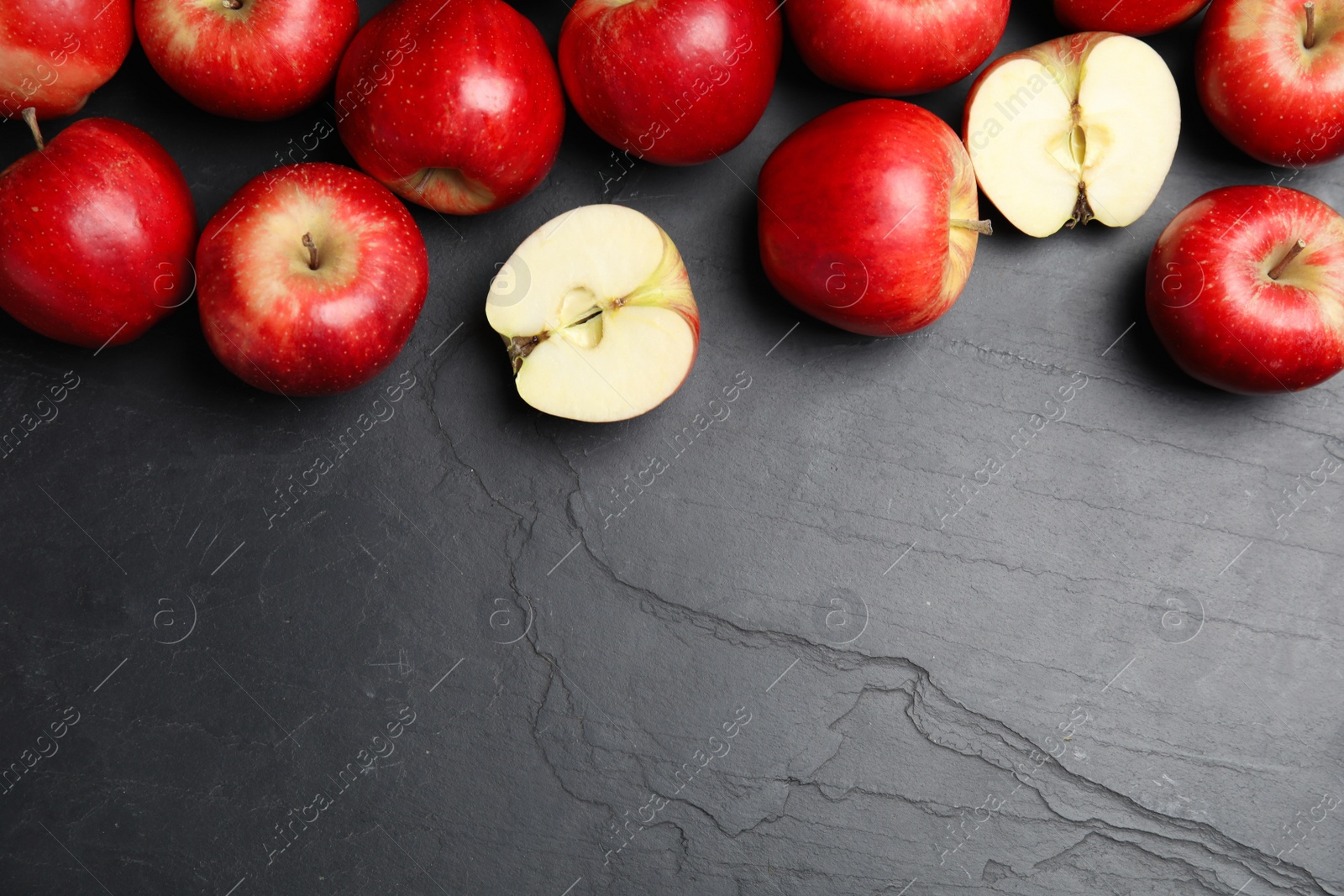 Photo of Fresh ripe red apples on black table, flat lay. Space for text