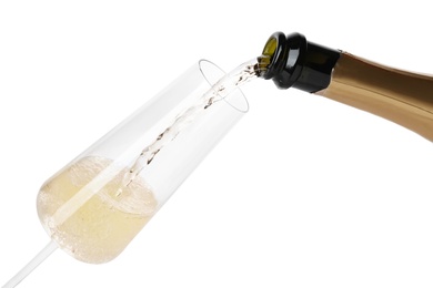 Photo of Champagne pouring from bottle into glass isolated on white