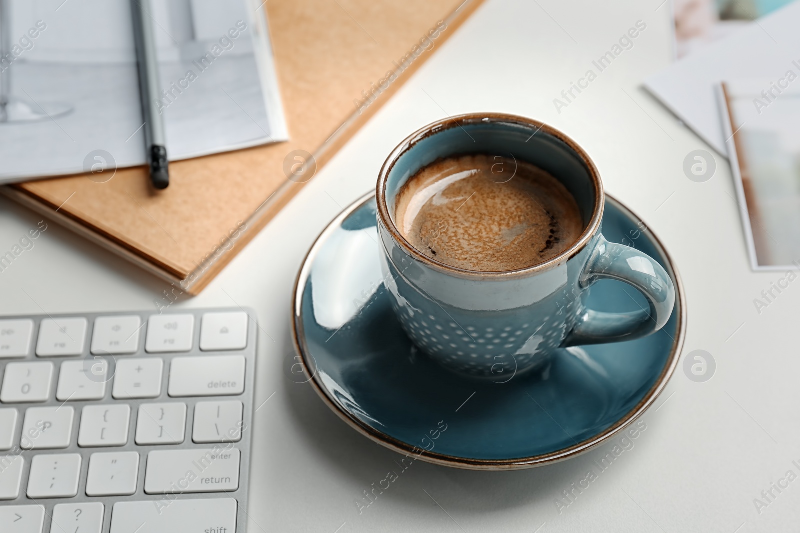 Photo of Cup of delicious hot coffee on table