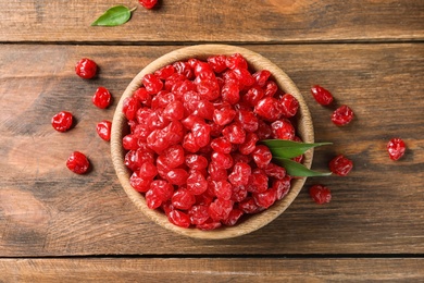 Photo of Bowl with tasty cherries on wooden background, top view. Dried fruits as healthy food