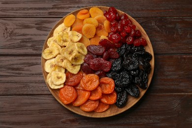 Photo of Delicious dried fruits on wooden table, top view