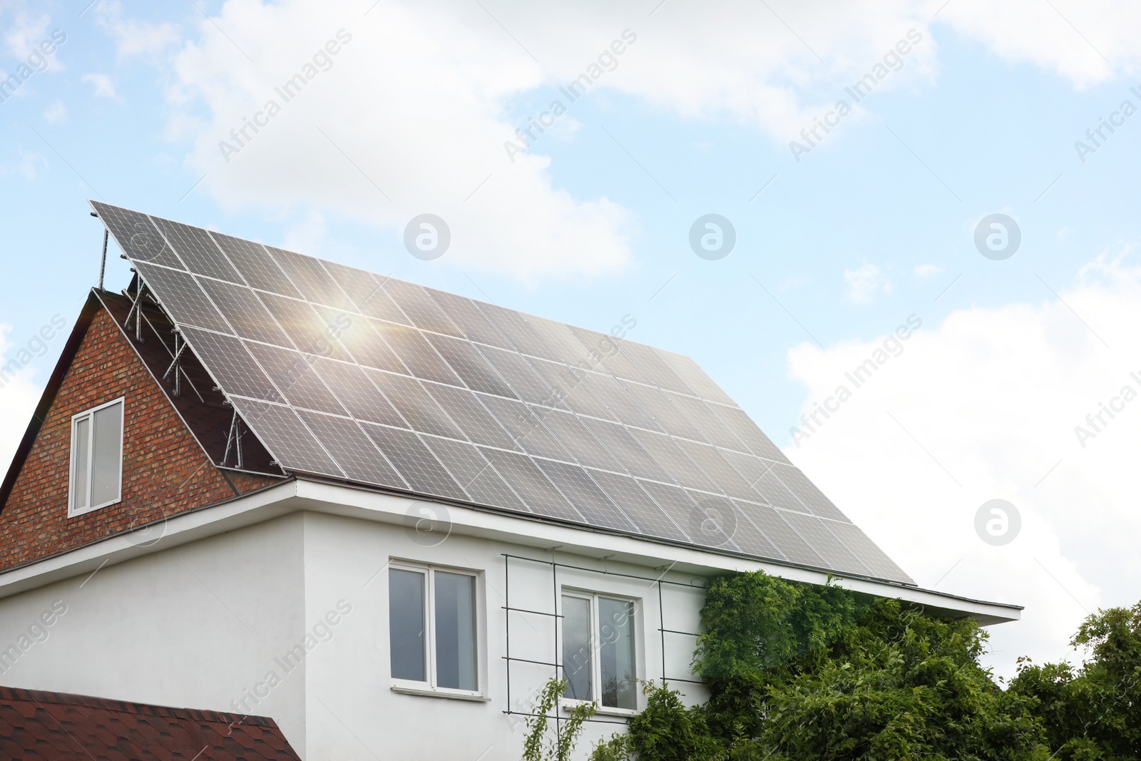 Photo of Building with installed solar panels on roof. Alternative energy source