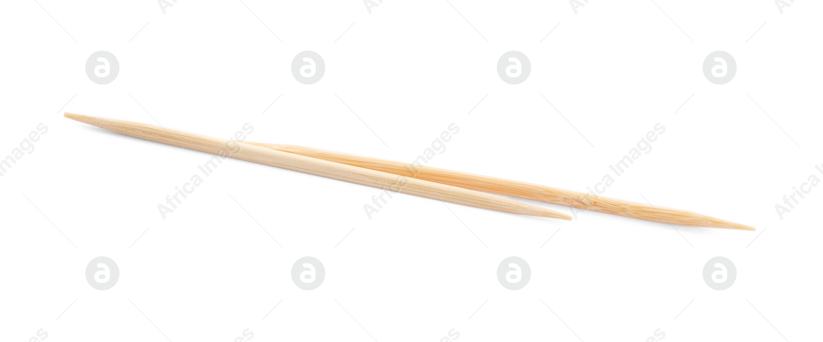 Photo of Two disposable wooden toothpicks on white background