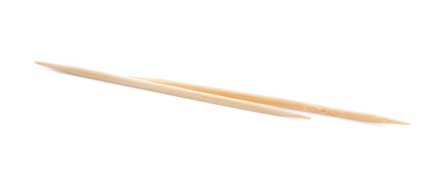 Two disposable wooden toothpicks on white background