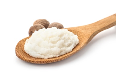 Photo of Spoon of shea butter and nuts on white background