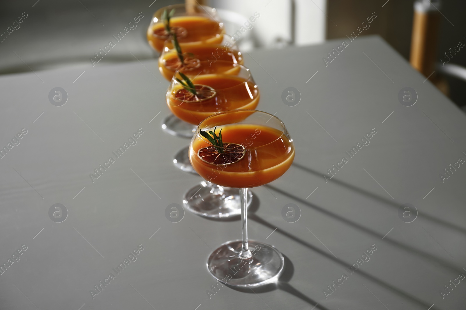 Photo of Glasses of delicious cocktail with vodka on table in bar