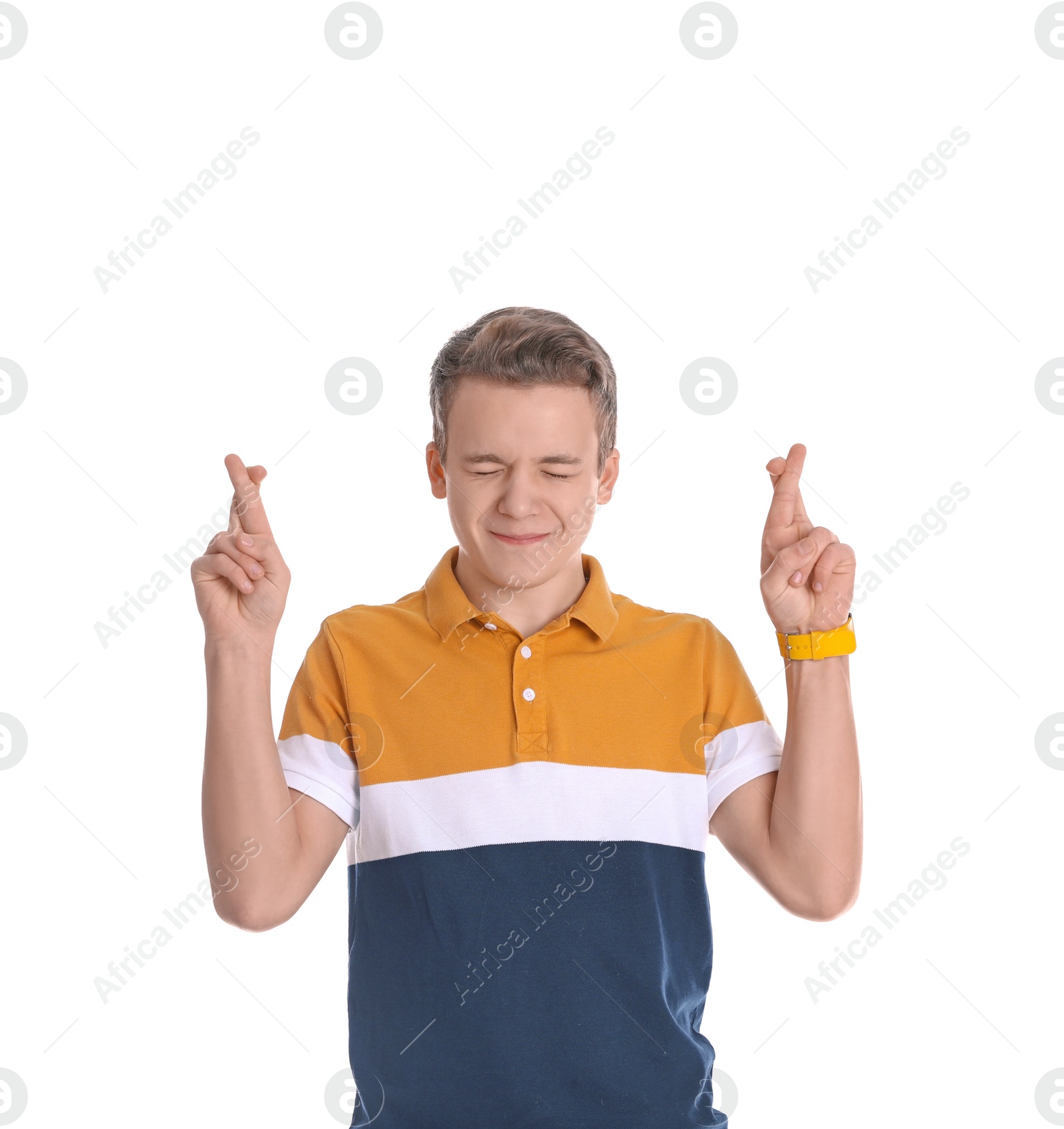 Photo of Handsome teenage boy crossing his fingers on white background