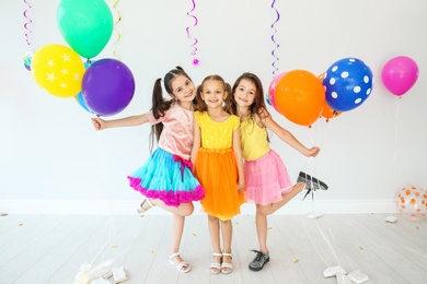 Adorable little girls at birthday party indoors