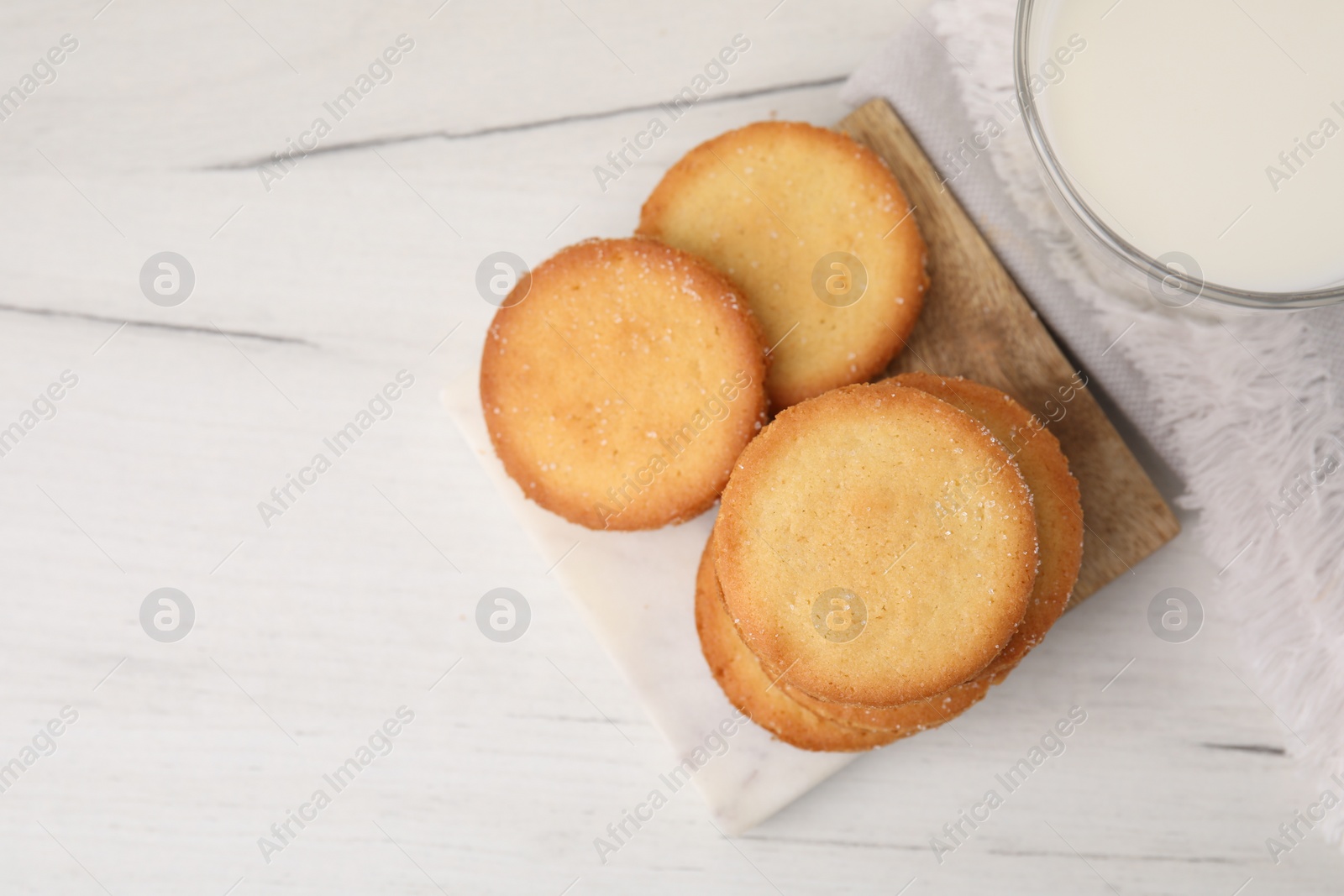 Photo of Tasty sweet sugar cookies on white wooden table, top view. Space for text