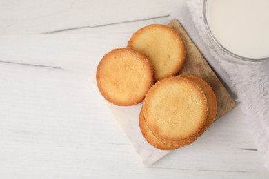 Photo of Tasty sweet sugar cookies on white wooden table, top view. Space for text