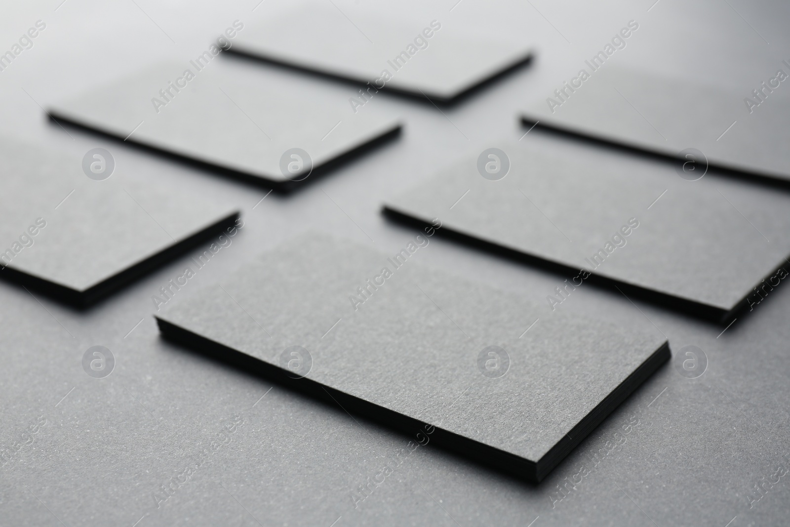 Photo of Blank business cards on black background, closeup. Mockup for design